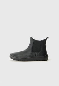 Black ankle boot made of textured leather with elastic side panels, a pull tab, and a rubber sole for grip. Classic chelsea design.
