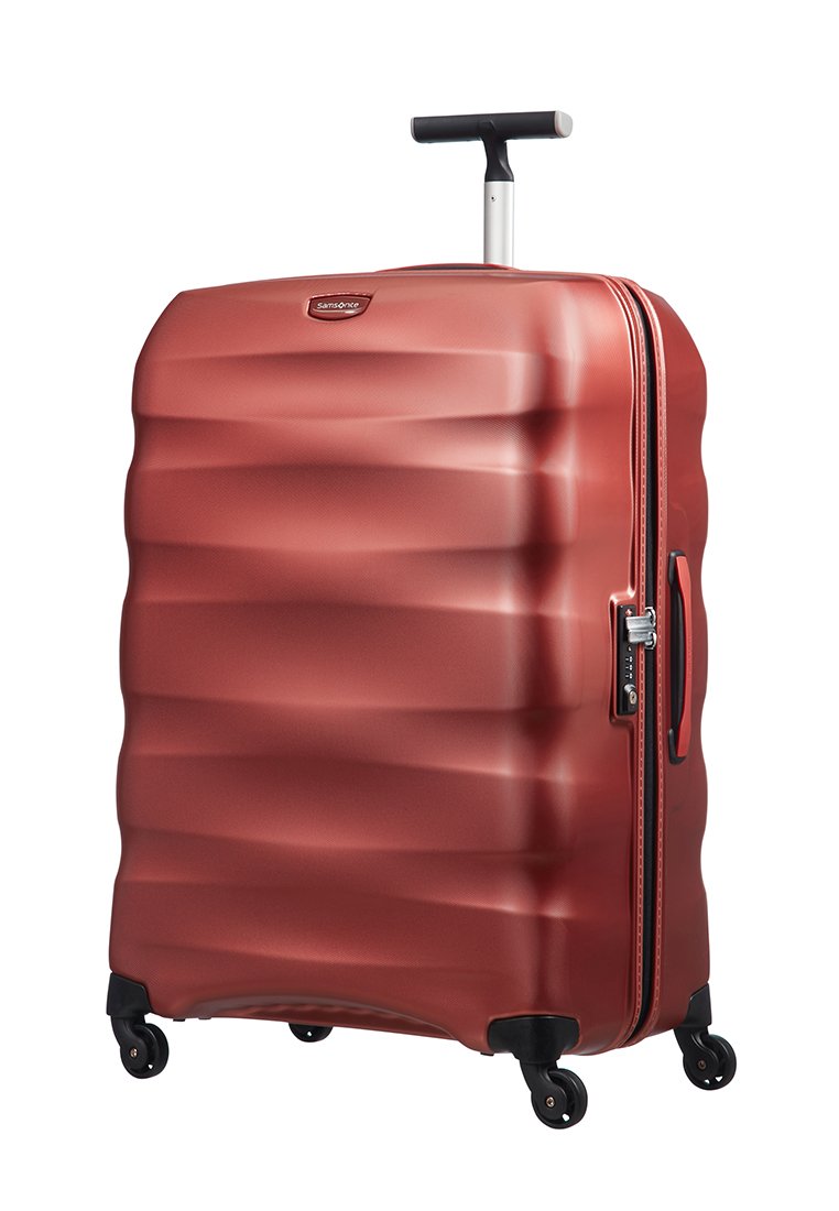 Rood harde koffer met een golfpatroon, aluminium handvat en vier wielen. Beschikt over een rits en een zijhandvat voor gemakkelijk dragen.