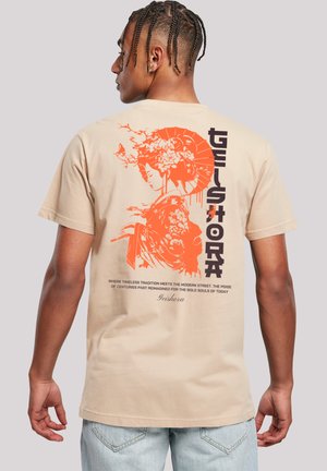 Beige cotton t-shirt featuring an orange graphic of a geisha and text on the back. Short sleeves and relaxed fit.
