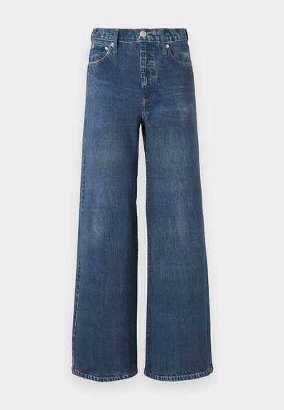 Jeansy dzwony z denimu w ciemnym niebieskim kolorze z delikatnie spranym efektem, wyposażone w zapięcie na guzik i suwak, szlufki na pasek oraz klasyczny fason z pięcioma kieszeniami.