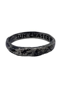 Metal ring with a textured, rustic surface. The inside features the engraved text "SUN CHASER." Color is dark, with a matte finish.