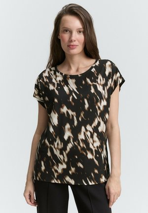 Blouse à manches courtes en noir, marron et crème avec un motif abstrait. Tissu lisse avec une coupe décontractée et un col rond.