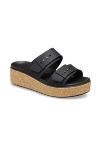 Sandales noires à plateforme avec double bride réglable, semelle intermédiaire en liège, semelle intérieure texturée et petites clous décoratifs dorés sur les brides.
