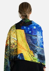 Écharpe colorée mettant en avant l'œuvre de Van Gogh avec des motifs vibrants. Tissu doux avec un design drapé, mettant en valeur des bleus, des jaunes et des verts.