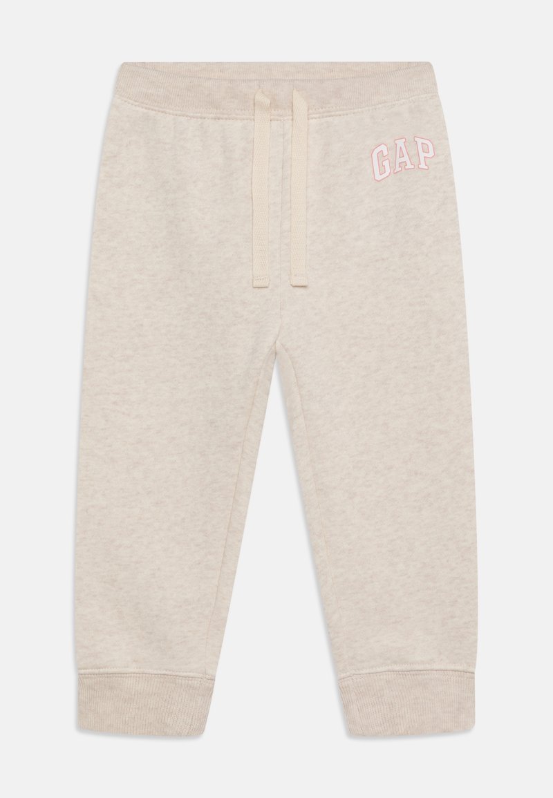 Pantalon de jogging beige clair pour tout-petit avec taille élastique, cordon crème, poignets côtelés et logo "GAP" rose sur la hanche gauche.