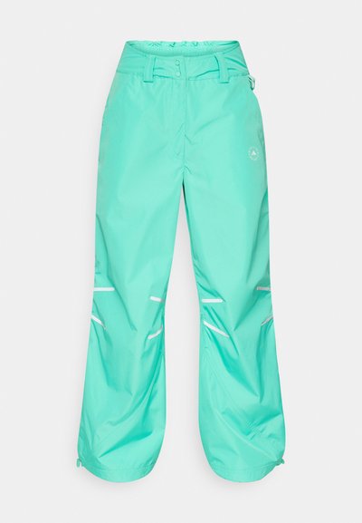 Vedenkestävät turkoosit housut, rento istuvuus, säädettävä vyötärö, heijastavat raidat ja vetoketjulliset lahkeet lisäävät toimivuutta.