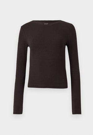 Hosszú ujjú felső sötétbarnában, puha, rugalmas anyagból készült. Kerek nyakkivágással és testhezálló fazonnal rendelkezik, amely alkalmas rétegezésre.