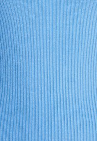 Žebrovaná látka v světle modré barvě se svislými pruhy. Hladký povrch s mírným leskem, což naznačuje syntetický nebo směsový materiál.