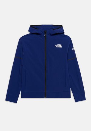 Veste à capuche bleue zippée avec fermeture éclair noire, logo The North Face sur la poitrine et logo Mountain Athletics sur la manche gauche.