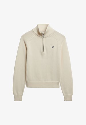 Suéter de punto color crema con cuello alto acanalado, media cremallera, mangas largas y pequeño logotipo negro bordado en el lado izquierdo del pecho.