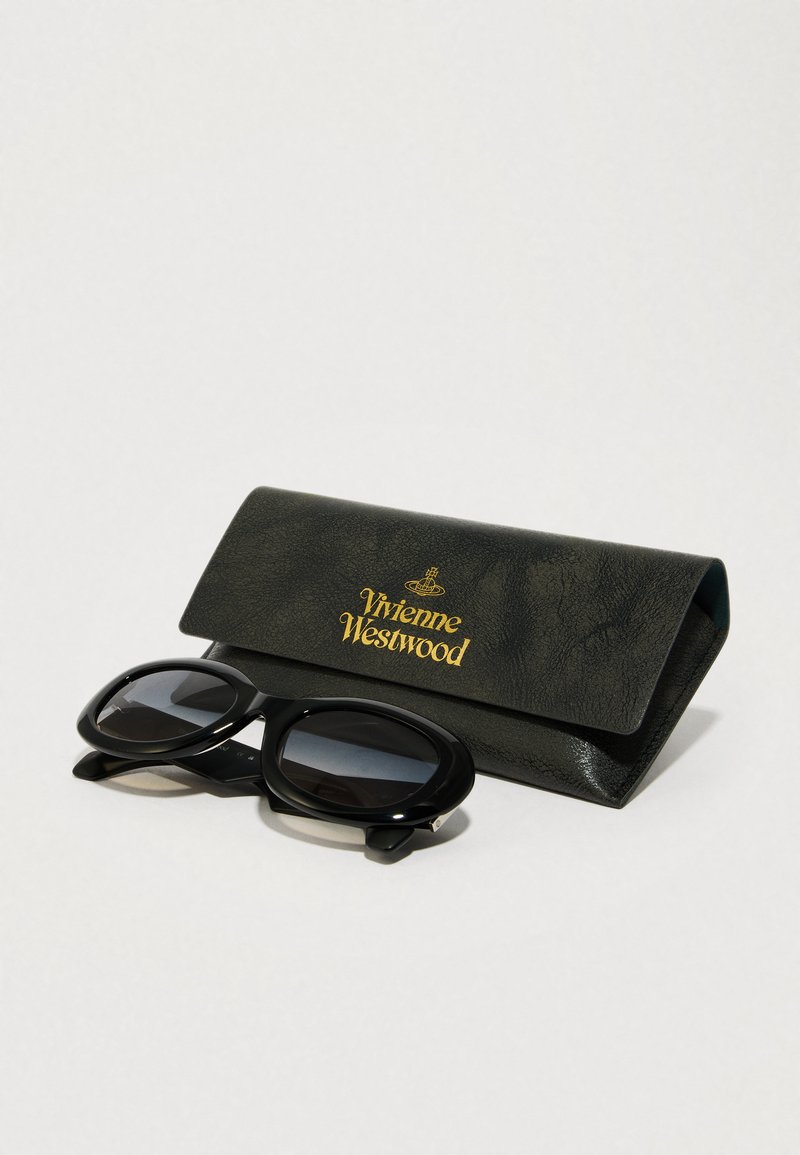 Black oversized sunglasses with dark lenses, accompanied by a textured black case featuring gold "Vivienne Westwood" logo.