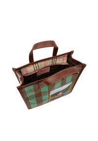 Sac fourre-tout en tissu à carreaux vert et marron, avec des poignées en cuir marron, fermeture éclair et un patch coloré représentant un paysage sur le côté. Intérieur doublé.
