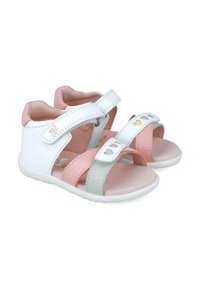 Open-toe sandalen voor kinderen met witte, roze en mint kleurige banden; hartvormige uitsparingen op de voorste banden en klittenbandsluitingen.