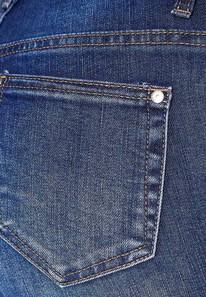 Denim jeans feature a blue fabric with a light wash, accented by brown stitching, and a single rear pocket with a metal rivet.