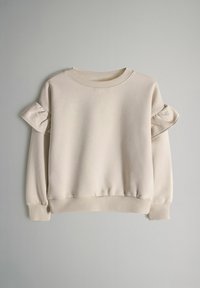 Lichtbeige sweatshirt met opgepofte schouderruffels, geribde ronde hals en geribde manchetten. Zachte stof met een ontspannen pasvorm.