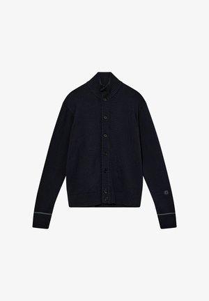 Navy knitted cardigan with a high ribbed collar, button closure, long sleeves, and ribbed cuffs and hem; features a small logo on the sleeve.