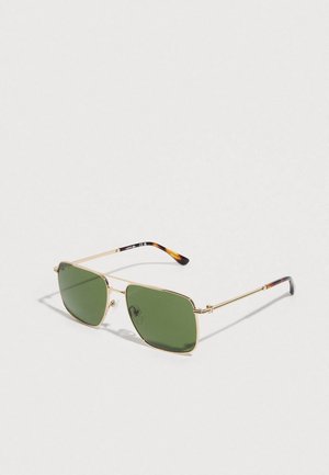 Gold metal frame sunglasses with green rectangular lenses and tortoiseshell tips on the arms, set against a plain light background.