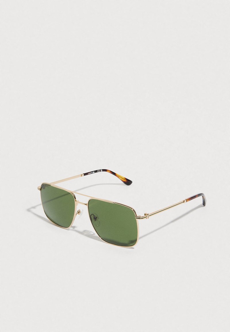 Gold metal frame sunglasses with green rectangular lenses and tortoiseshell tips on the arms, set against a plain light background.