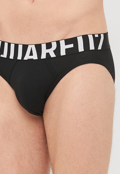Black brief-style underwear with a wide white elastic waistband featuring black lettering. Smooth fabric with a snug fit.