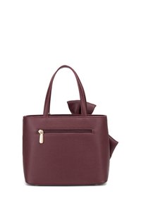 Borsa a tracolla in pelle color bordeaux con forma strutturata, doppi manici, tasca esterna con zip e un elegante fiocco decorativo su un lato.