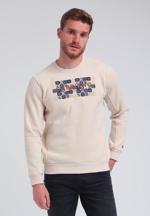 Crème sweatshirt met een textuur grafische print in blauw en rood. Heeft ribgebreide hals en cuffs, en detailing aan de zijkanten. Soepele stof.