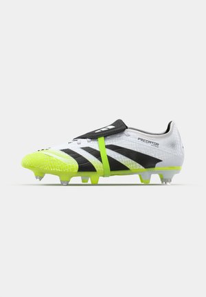 White and black soccer cleat with bright green accents, featuring a textured upper, strap design, and molded studs for traction.
