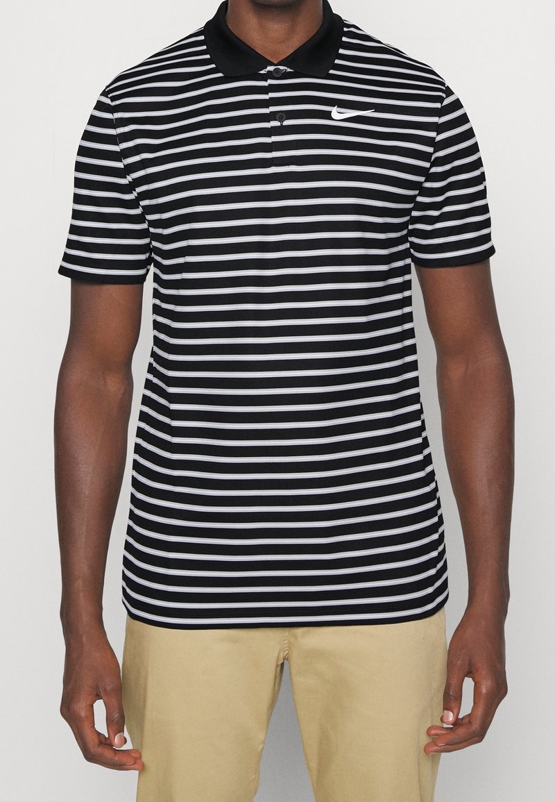 Black and white striped polo shirt with a black collar and Nike logo on the left chest. Short sleeves with flat-knit cuffs.