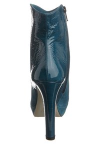 Teal high-heeled ankle boot with a glossy patent leather finish, suede accents, pointed toe, and side zipper detail.