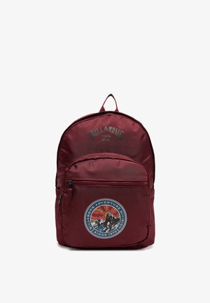 Dark red Billabong backpack with front zip pocket and a round patch featuring a mountain, sun, and river design.