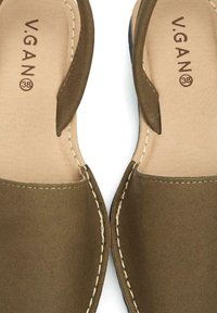 Brown vegan sandals with an open toe design, leather-like texture, and contrasting stitching details. Size 38 marked on the insole.