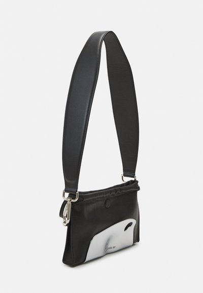 Black leather crossbody bag with a smooth finish, featuring a silver accent on the front, and a wide, adjustable strap.