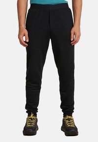 Schwarze sportliche Jogginghosen mit lockerem Sitz, elastischem Bund und zulaufenden Bündchen. Weiche Stofftextur und minimalistisches Design.