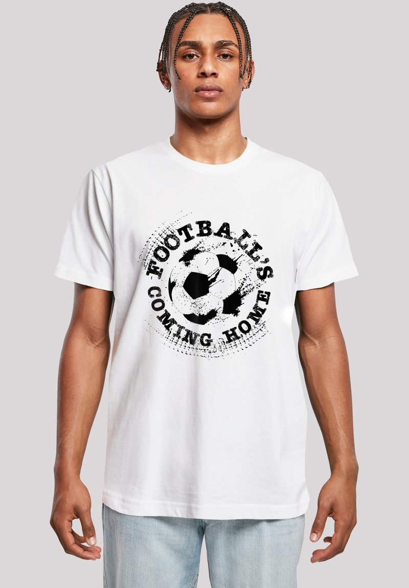 White cotton t-shirt featuring a black graphic of a soccer ball with the text "Football's Coming Home" in a distressed font. Regular fit.