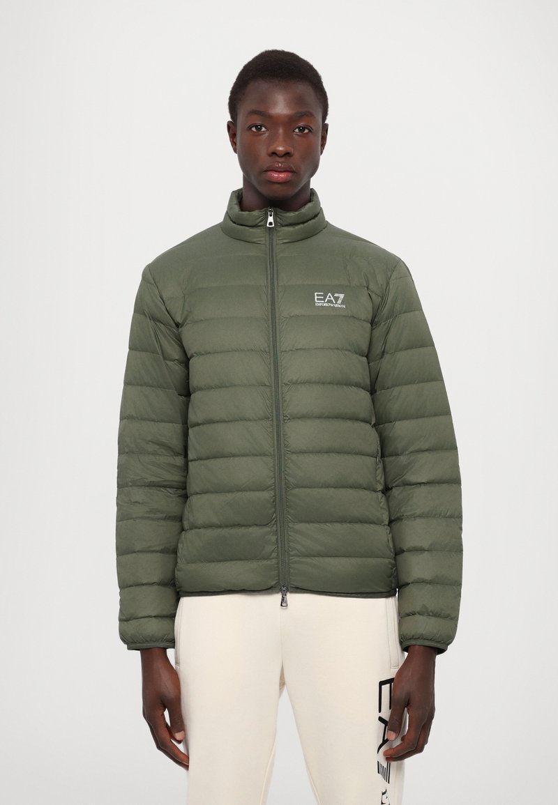 Green puffer jacket with quilted sections, high collar, front zipper, and EA7 logo on the chest. Textured, lightweight fabric.