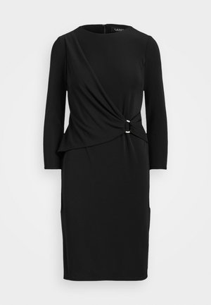 Black long-sleeve dress with a knot detail at the waist, featuring a round neckline and two pockets, made from a smooth, stretchy fabric.