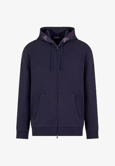 Felpa con zip colore navy, con una texture a coste, cordini e due tasche anteriori. Presenta un rivestimento a motivo nella cappuccio.