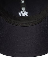 Black baseball cap with a smooth textured fabric, a curved brim, and white embroidered logo details inside the cap.