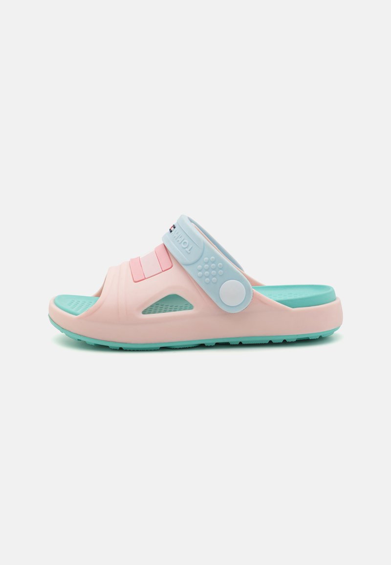 Pink and blue slip-on sandal made of rubber, featuring a textured sole, ventilation holes, and an adjustable strap with a circular accent.