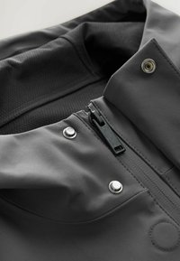 Gray hooded jacket with a smooth surface, featuring a zipper, snaps, and a textured inner lining for added comfort and style.