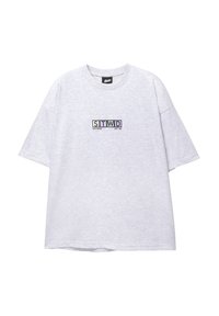Light gray oversized T-shirt made of cotton, featuring a colorful printed logo "STWD" on the chest. Short sleeves and round neckline.