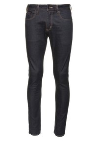 Kapeat tummansiniset farkut oransseilla saumoilla. Varustettu etutaskuilla, vetoketjusuljeksella ja suoralla lahjemallilla.