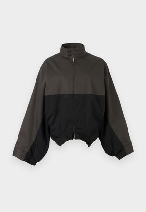 Jachetă cu fermoar, neagră și gri închis, cu guler înalt, clapetă cu nasturi și mâneci în stil balon, afișată pe un fundal alb.