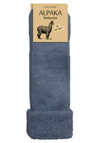 Socken aus Alpaka-Wolle in Dunkelblau mit strukturiertem Muster. Verfügt über einen kuscheligen, flauschigen Bund für zusätzliche Wärme und Komfort. Die Verpackung enthält eine Illustration.