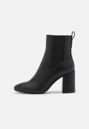 Black leather ankle boots with a pointed toe, block heel, and elastic side panels. Smooth texture with a back pull tab for easy wear.