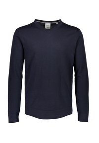 Maglione a V blu navy in un morbido tessuto lavorato a maglia, con maniche lunghe e polsini a costine. Presenta una superficie liscia e un fondo curvo.