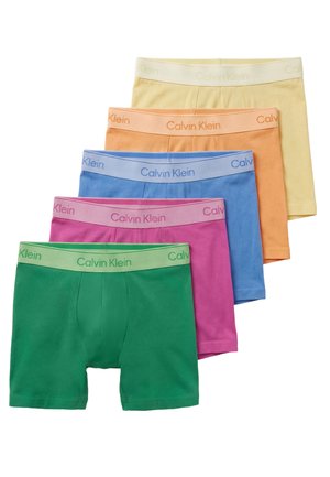 Five pairs of Calvin Klein boxer briefs in green, pink, blue, orange, and yellow, stacked in a staggered arrangement.