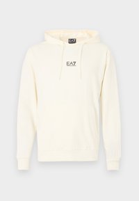Bawełniana kremowa bluza z kapturem z kieszenią kangurka, ściągaczami na rękawach i dole. Na piersi znajduje się małe czarne logo EA7.