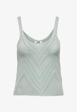 Top de punto verde claro con un patrón en forma de zigzag, tirantes finos y una textura suelta y aireada. Etiqueta visible en el centro.