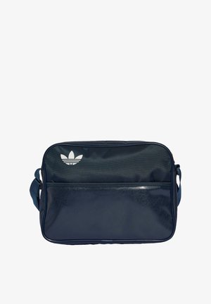 Saco de ombro azul marinho feito de material sintético, com um bolso frontal com fecho e um logo branco. Textura suave com um formato retangular.