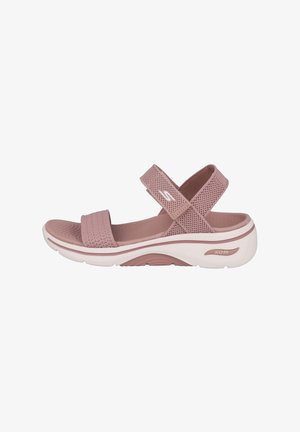 Sandalias de mujer con parte superior de malla rosa, correas ajustables y una suela blanca acolchada que presenta soporte de arco contorneado.